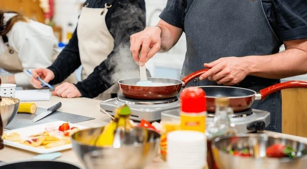 cooking-crowded-kitchen-cookery-workshop-600nw-2574198139